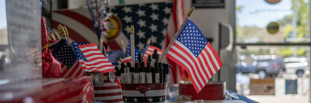 Picture of little American flags, pens, and other trinkets on a table inside the main hallway/lobby of the Sonoma County Registrar of Voters Office