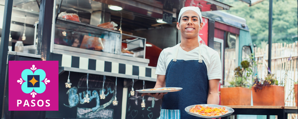 Food truck employee smiling with food and pasos logo
